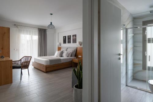 a bedroom with a bed and a desk with a chair at Leon Villas in Nikiti