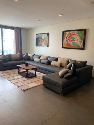 a living room with a couch and a coffee table at Ocean View Apartment - Anfa Place - in Casablanca