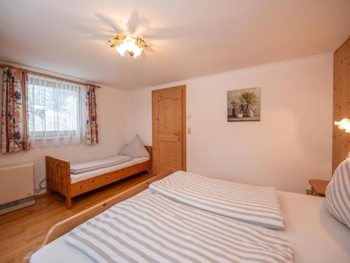a bedroom with a bed and a window at Apartment in Wald near Krimml Waterfalls in Wald im Pinzgau