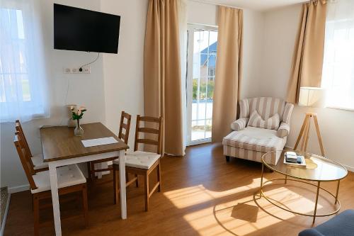a living room with a table and a chair at Holiday Apartment Sweden House in Lütjenburg