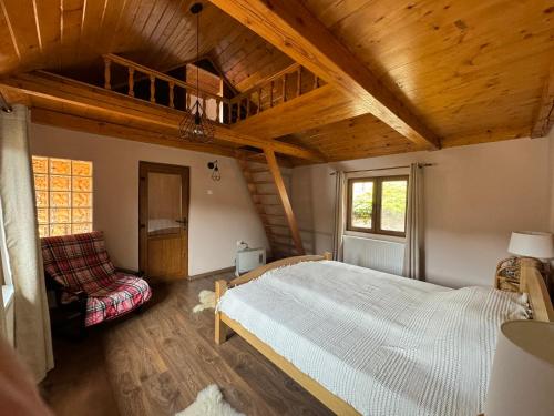 a bedroom with a white bed and a wooden ceiling at Villa Garden Balvanyos in Turia