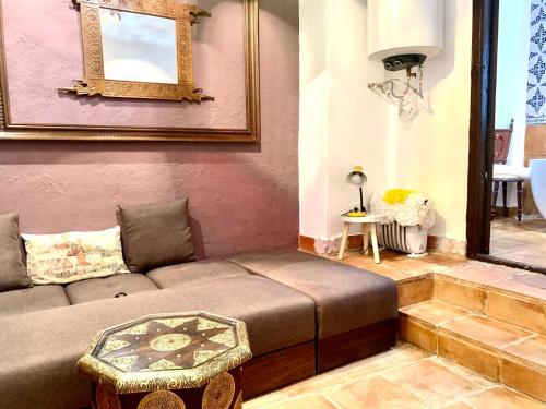 a living room with a couch and a mirror at Casa Basilia in Granada