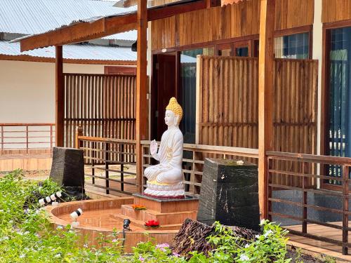 a statue sitting in front of a building at Lemon Grass Resort & Spa in Havelock Island