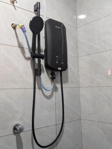 a soap dispenser on a wall in a bathroom at Din's Studio Homestay in Semporna