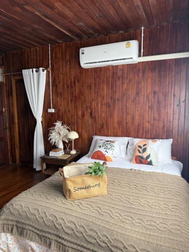 a bedroom with a bed with a box on it at Tueng ha เติง หา ที่พักงาว in Ban Rong