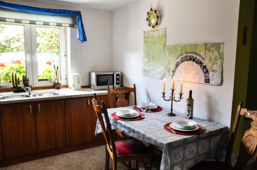 a kitchen with a table and a sink at Oaza U Tadeusza in Augustów