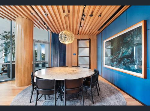 a dining room with a large table and chairs at Ultra Luxury 1BR with Study beside Crown Sydney, with All AMENITIES! And sleeps 5! in Sydney