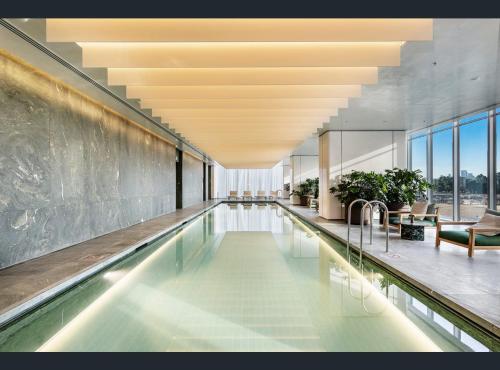 a swimming pool in a building with a ceiling at Ultra Luxury 1BR with Study beside Crown Sydney, with All AMENITIES! And sleeps 5! in Sydney