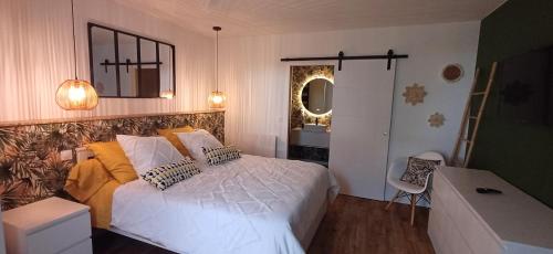 a bedroom with a large white bed and a desk at Le petit Arrigade in Mimbaste