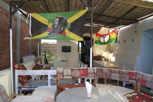 a room with a table and chairs and a flag at One Love Guesthouse & Restaurant in Luxor