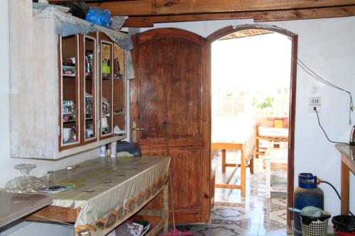a kitchen with a wooden cabinet in a room at One Love Guesthouse & Restaurant in Luxor