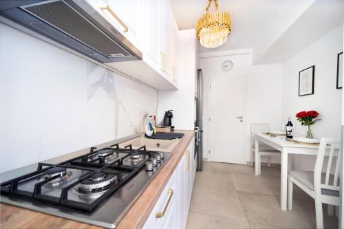 a kitchen with a stove and a counter top at Modern Apartment with Free Private Parking in Timisoara in Timişoara