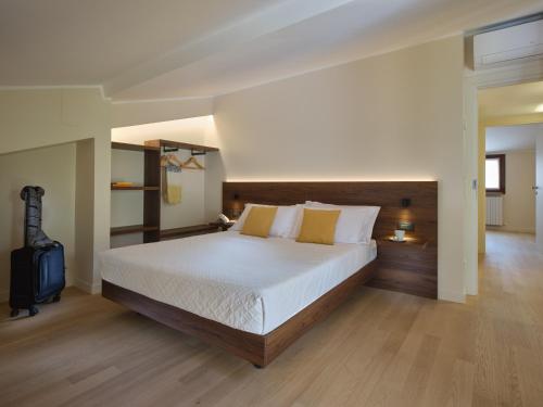 a large bedroom with a large bed with white sheets at Portica Homes Assisi in Assisi