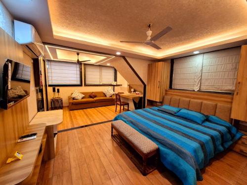 a bedroom with a large bed and a living room at Richhariya Nature's Retreat Homes in Jhānsi