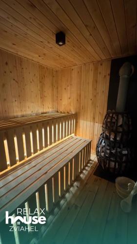 a sauna with a bench in a wooden room at Relax House Zviahel in Zwiahl