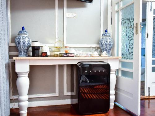 a microwave oven sitting under a table in a room at C'est La Vie Boutique Hotel in Witbank