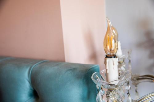 a glass vase with a light on top of a couch at MUZE Hotel Utrecht in Utrecht