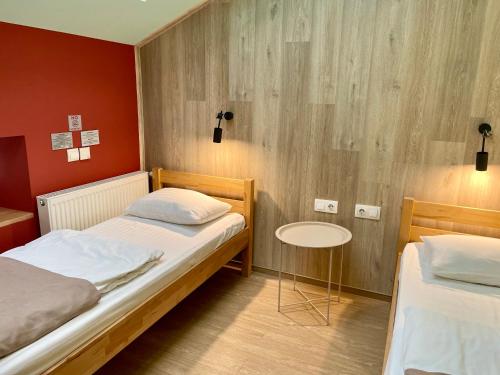 a room with two beds and a table in it at DREAM Hostel Lviv in Lviv