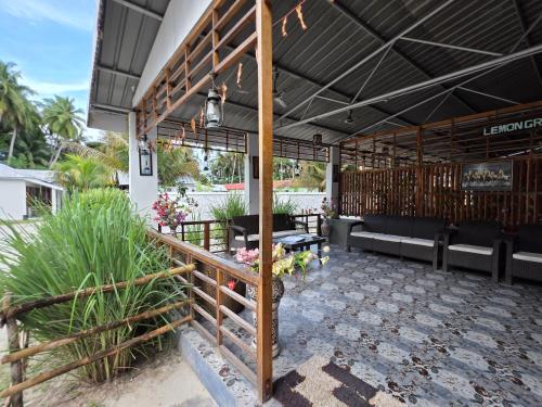 a patio of a restaurant with benches and flowers at Lemon Grass Resort & Spa in Havelock Island