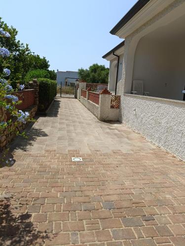 a brick walkway in front of a house at Bilo Lu Rattali in San Teodoro