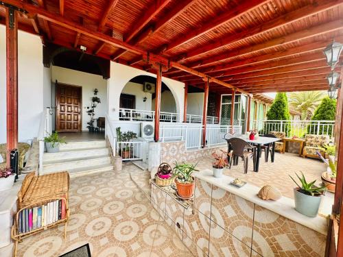 an outdoor patio with a table and chairs at Blue Panorama Crystal in Mákri