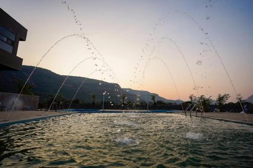 a fountain with water spraying into the air at Mountain Shadow Resort in Igatpuri