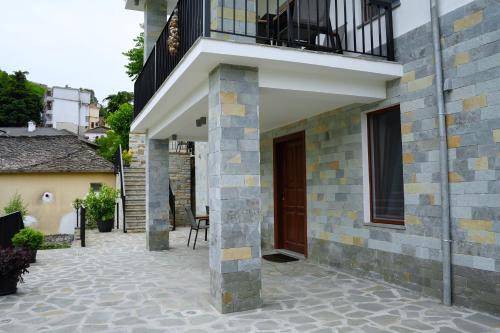 a side view of a house with a balcony at Castlefront Villa in Gjirokastër
