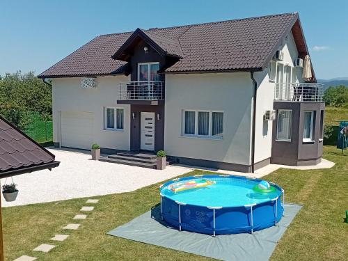 a house with a swimming pool in front of it at Villa 'Whispering Pines' Ilidža in Sarajevo