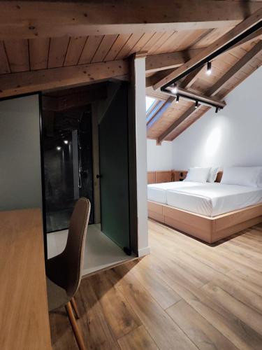 a bedroom with a bed and a chair in a room at Palorto Inn in Gjirokastër