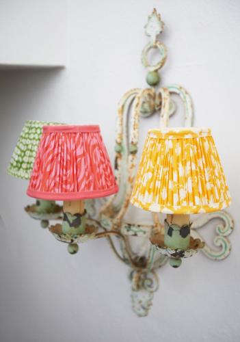 a chandelier with two lamps on a wall at La Sacristía in Tarifa