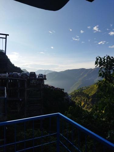 a view from the top of a mountain with cars on it at Sheetal Restaurant in Mussoorie