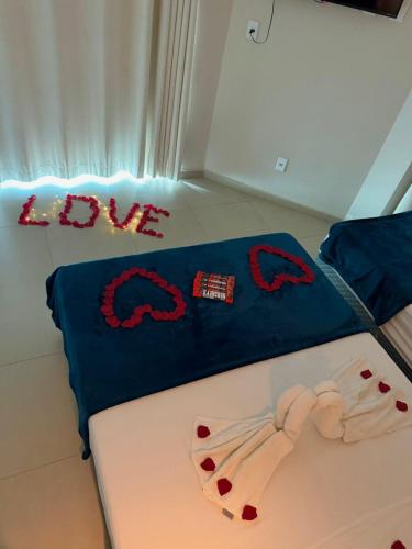 a bedroom with a bed with a batman blanket at Pousada La Acolhida in Cabo Frio
