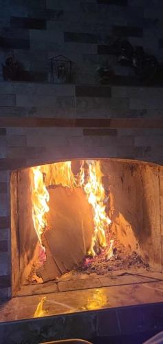 a brick oven with fire inside of it at Hotel DADU in Samtredia