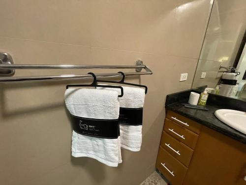 a bathroom with towels hanging on a towel rack at Studio condo near SM Clark, clark, & clark airport in Malabañas