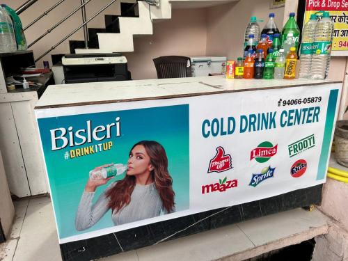 a billboard with a woman drinking a water bottle at Aniruddha Home Stay in Ujjain