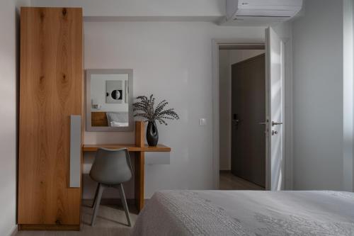 a bedroom with a desk and a chair next to a bed at Leon Villas in Nikiti