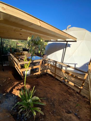 a wooden fence with an umbrella on top of it at Domos el Quillay in Concepción