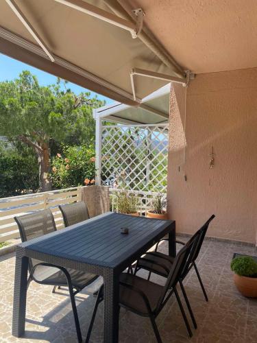 a black table and chairs on a patio at Cozy Apartments in Istron