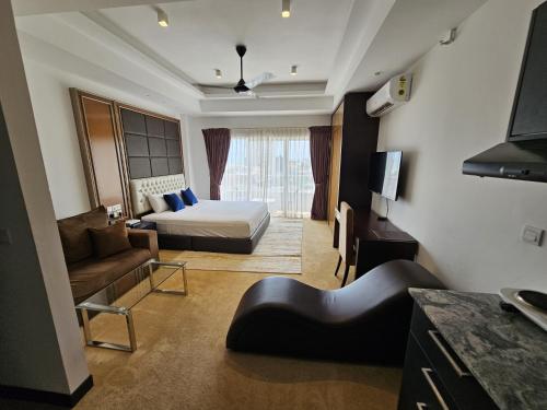 a hotel room with a bed and a couch at Ocean Breeze Sea View Luxury Apartments in Negombo