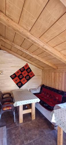a room with a bed and a table in a cabin at Etno SELO Uskoci in Uskoci