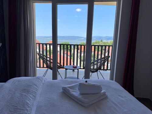 a bedroom with a bed and a view of a balcony at Moms house 2 in Golubac