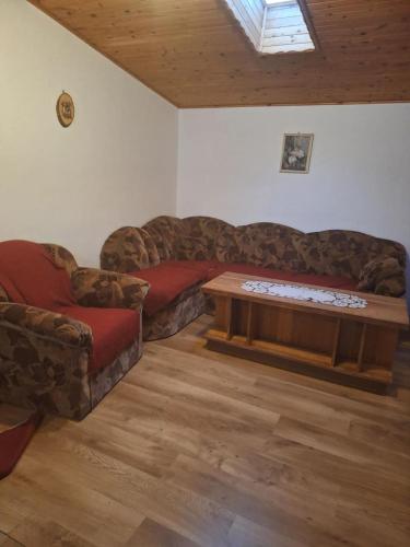 a living room with two couches and a coffee table at Chata Mária in Bojná