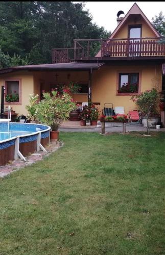 a house with a swimming pool in the yard at Chata Mária in Bojná