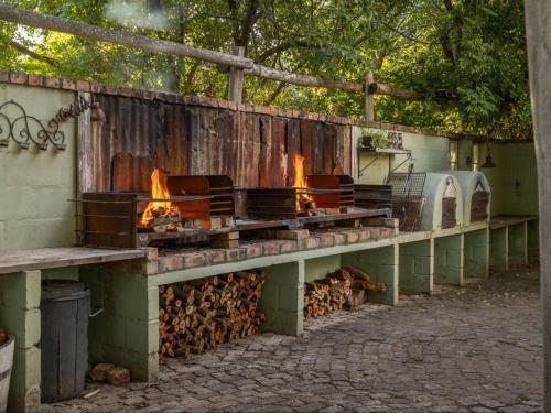 a brick oven with fire inside of a building at Caledon Grace Guesthouse in Caledon