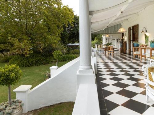 an outdoor patio with a checkered floor at Caledon Grace Guesthouse in Caledon