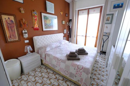 a bedroom with a bed with two towels on it at La Casa di Sole by PortofinoVacanze in Rapallo