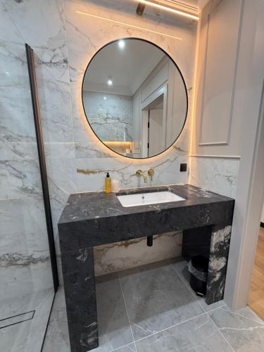 a bathroom with a sink and a mirror at Moris Beach Hotel in Gdańsk
