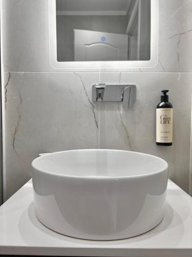 a white sink in a bathroom with a mirror at Samel Hotel in Siviri