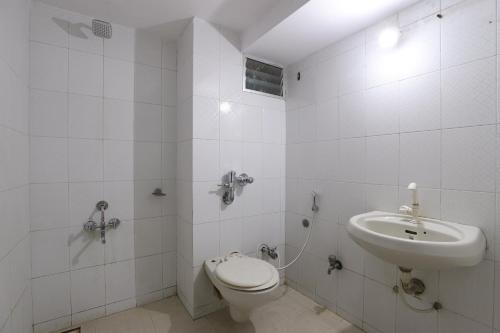 a bathroom with a toilet and a sink at SPOT ON Hotel Hilltop in Vadodara