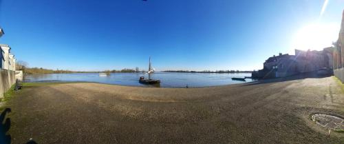 a view of a river with a boat in the water at Maison familiale charmante à Ingrandes in Ingrandes